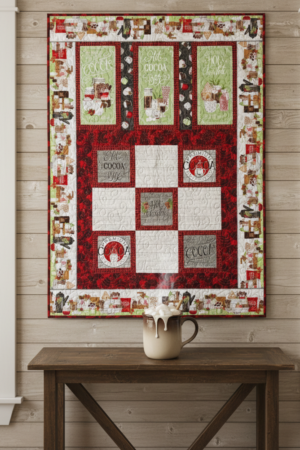 Handmade winter throw quilt with cocoa-themed panels, hot chocolate mugs, marshmallows, and festive red and green borders.