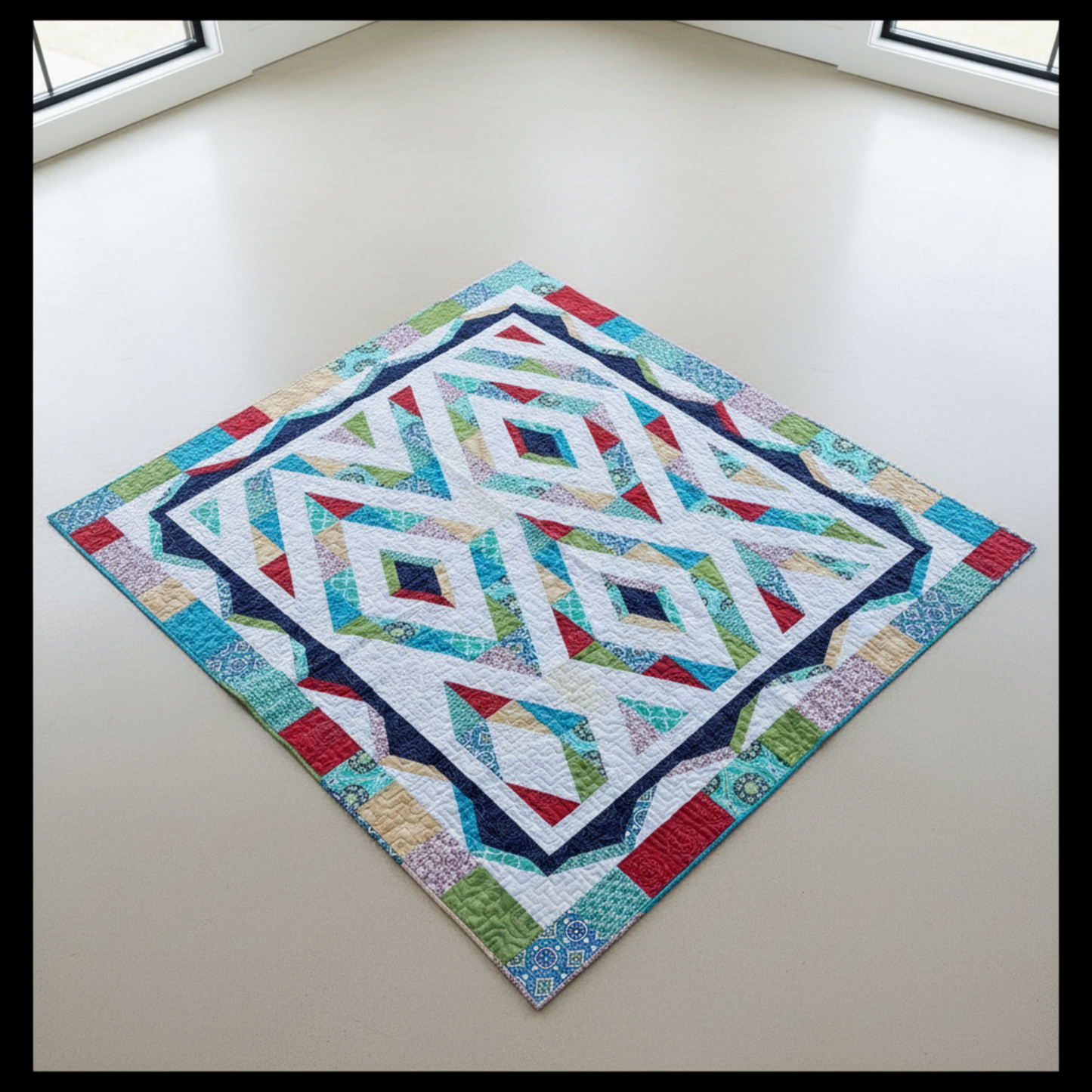 Modern handmade Prism quilt with colorful diamond pattern laid flat outdoors