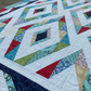 Close-up of diamond blocks and swirl quilting on Prism handmade quilt