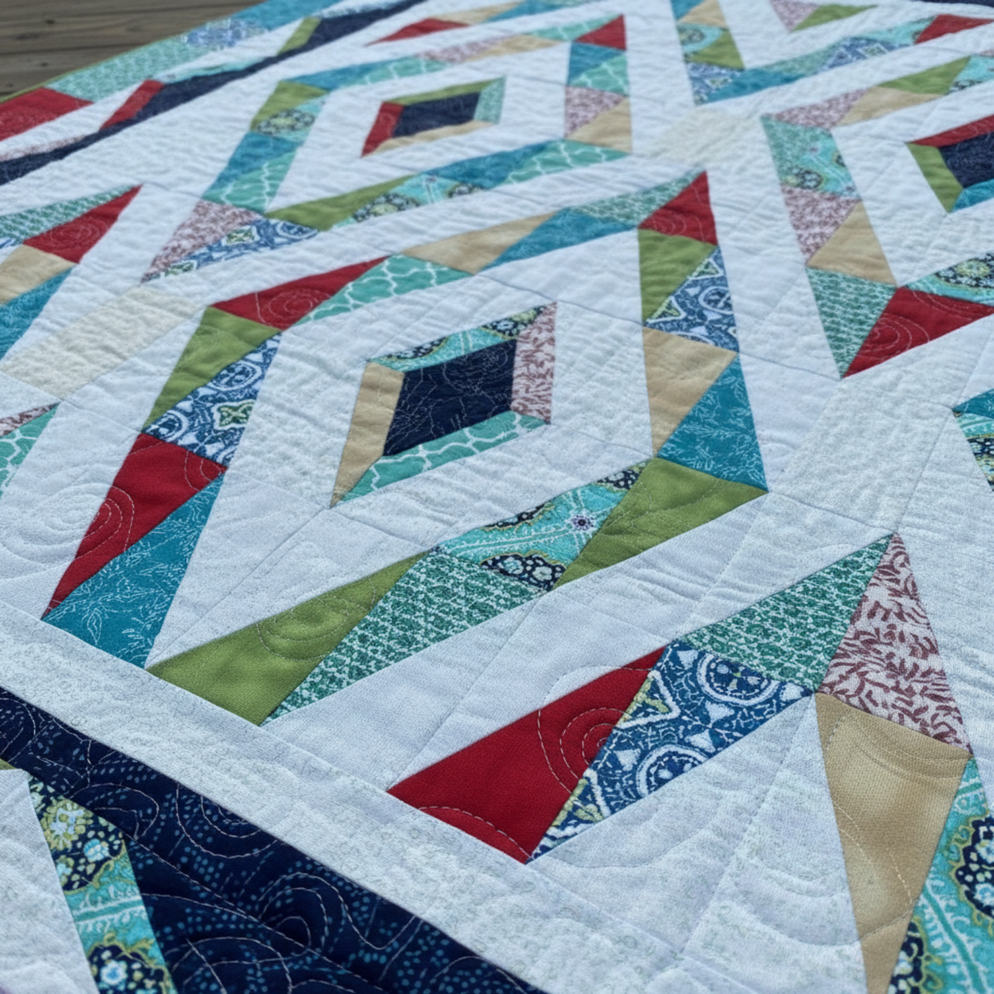 Close-up of diamond blocks and swirl quilting on Prism handmade quilt