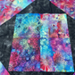 Colorful quilt block with abstract patterns on a black background. 