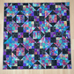 Handmade Jewels of the Night quilt laid flat showing jewel-toned patchwork design