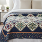 Vintage Sampler quilt draped over a bed showcasing classic design