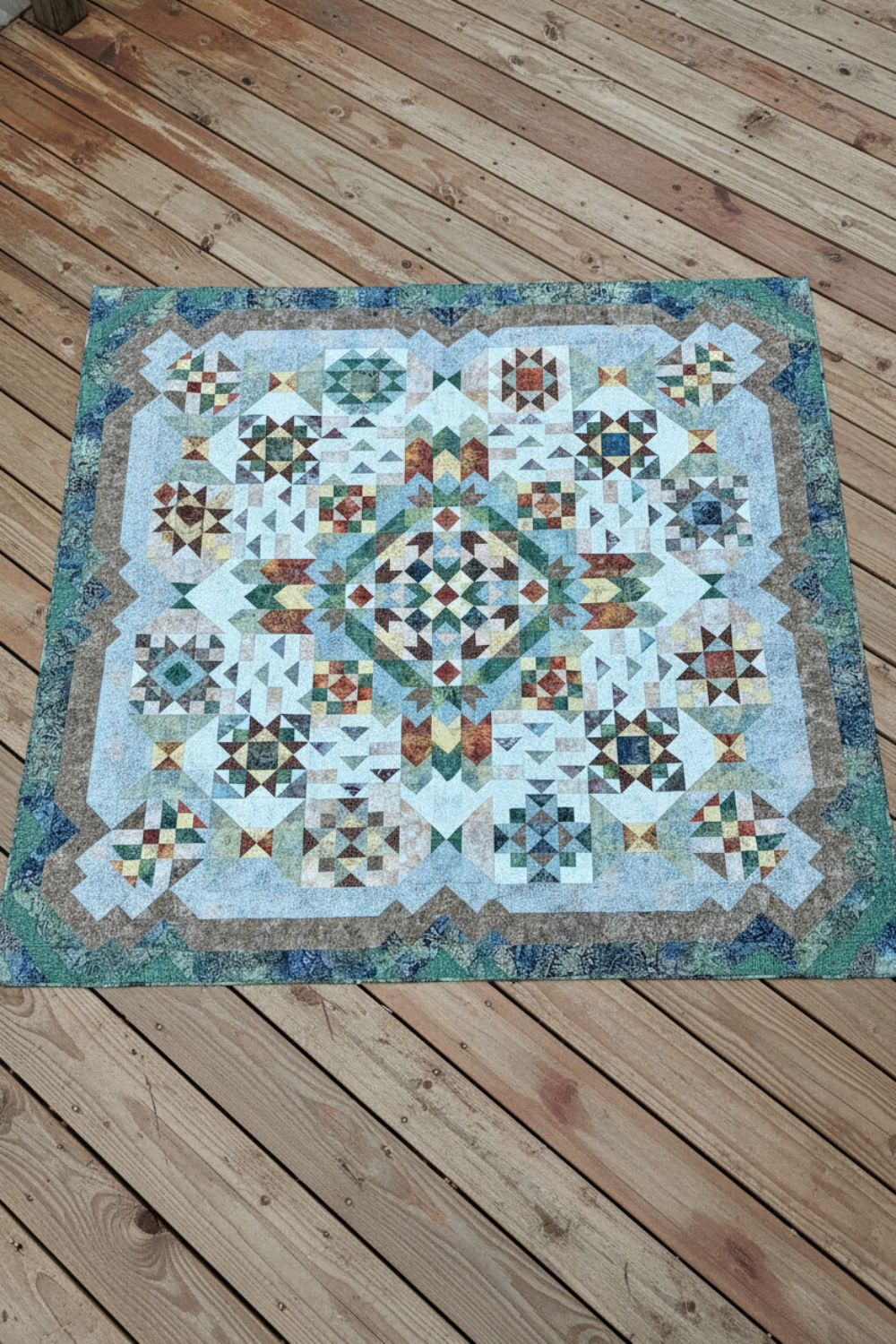 Full view of Windsong 108 x 108 inch king size quilt laid flat outdoors