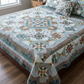 King-size bed styled with the Windsong handmade patchwork quilt in earthy seasonal tones