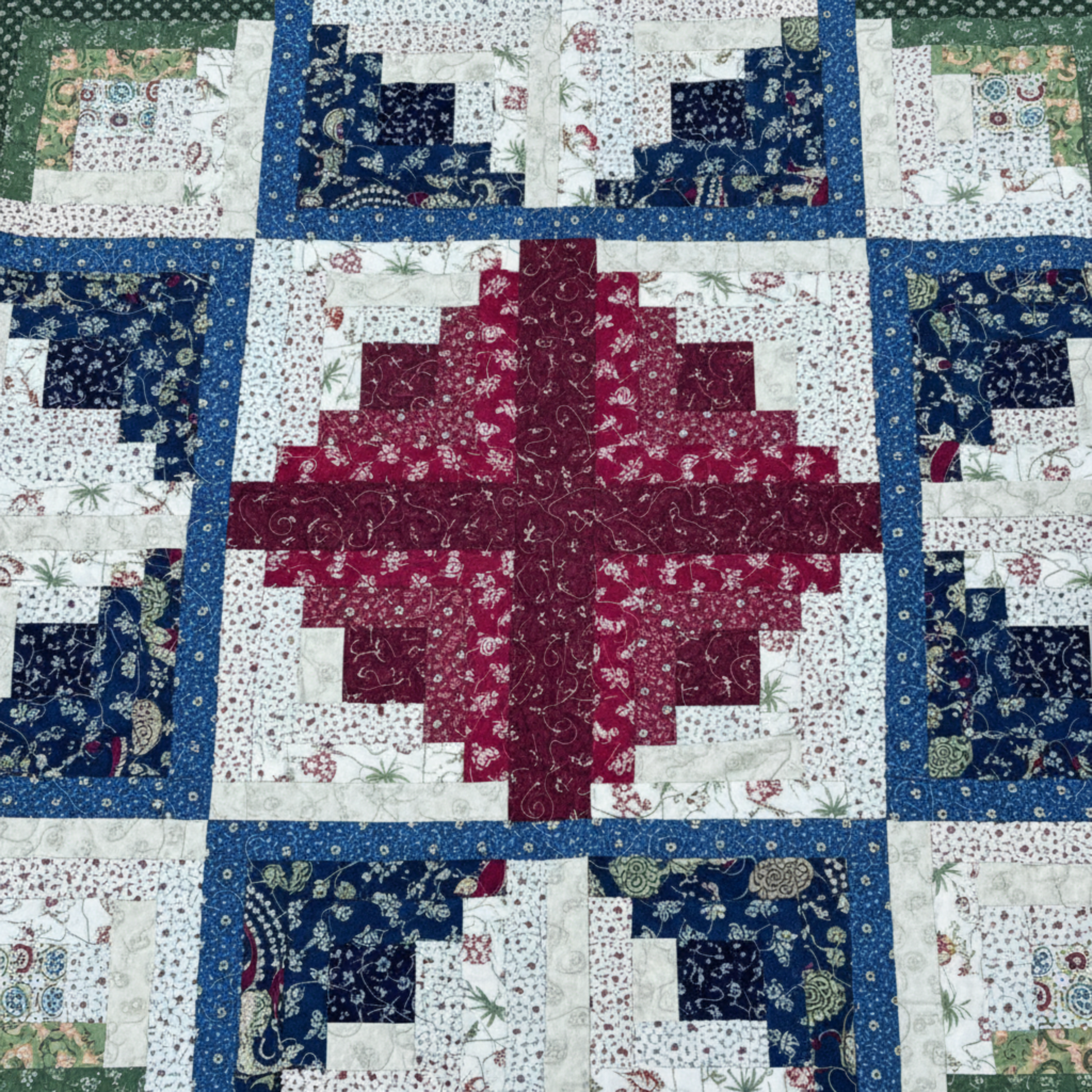 Close-up of log cabin star block showing fabric texture and craftsmanship