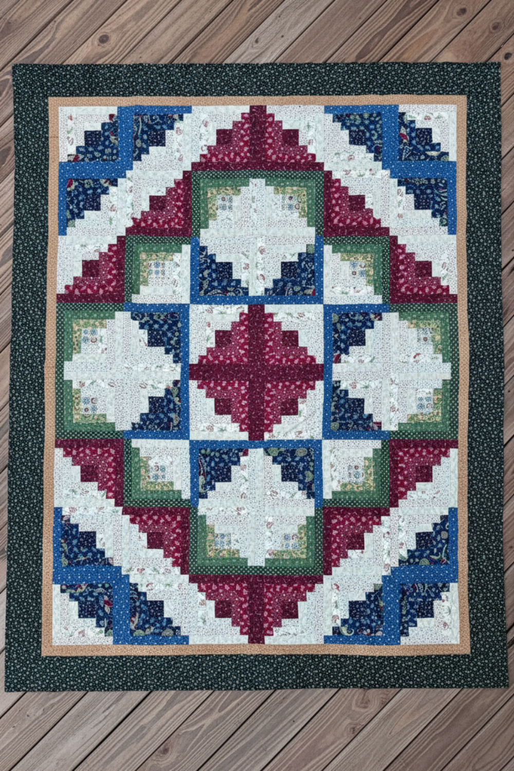 Handmade Log Cabin Star quilt laid flat showing full star layout and borders