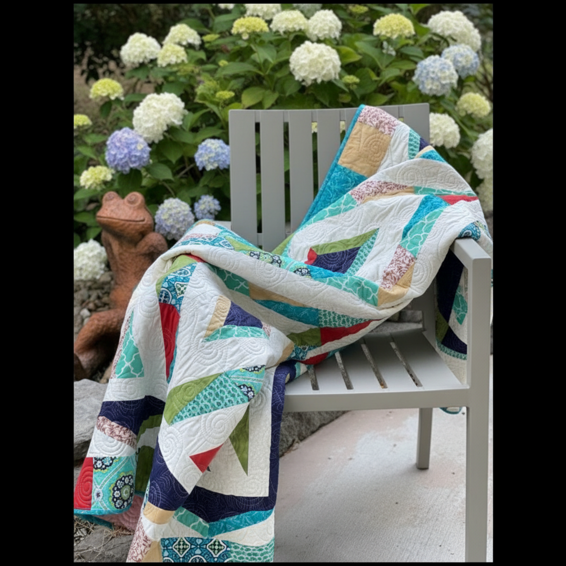 Colorful geometric Prism quilt draped over patio chair in natural light