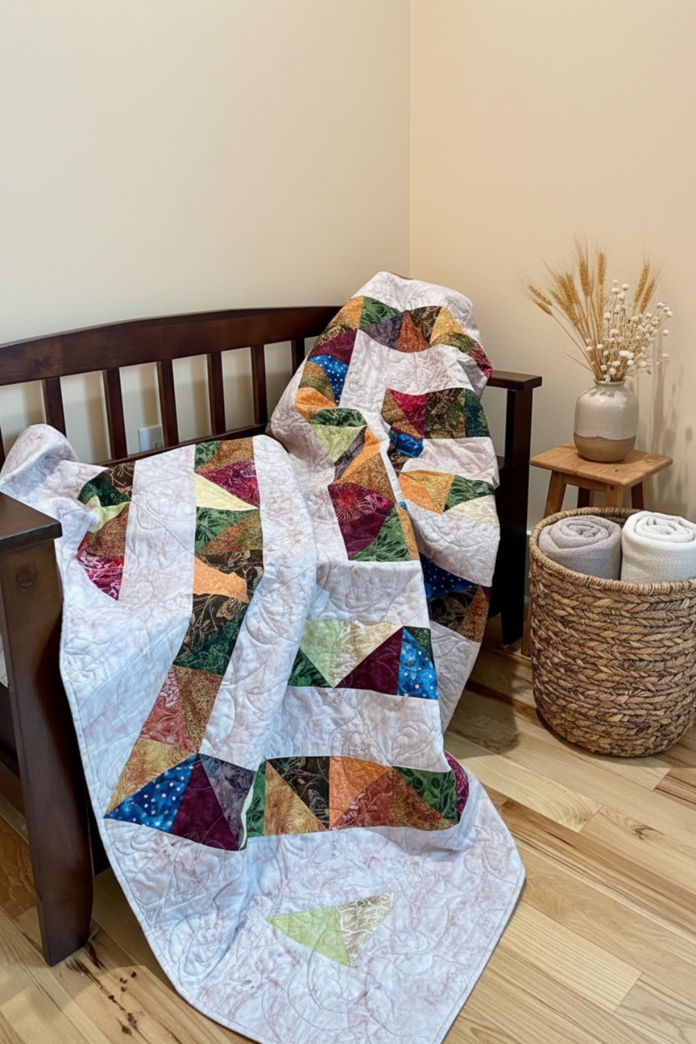 4‑Patch Charm quilt draped on a wooden bench indoors, displaying colorful patchwork fabric, quilting texture, and cozy scale.