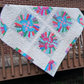 Colorful quilt with floral patterns on a wooden deck