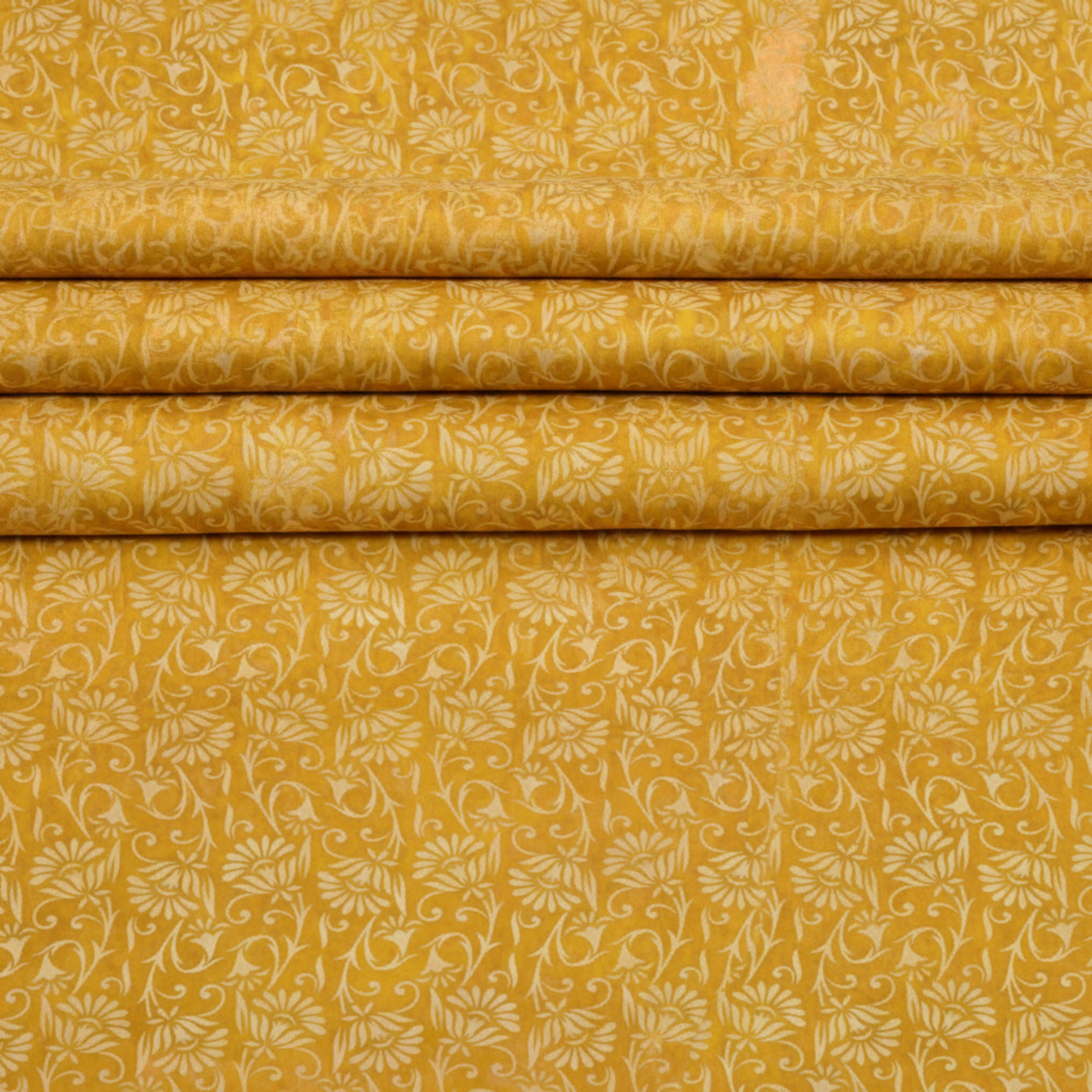 Prism II Yellow Blooms fabric draped to show natural movement and soft hand of 100% cotton with kaleidoscopic floral pattern design