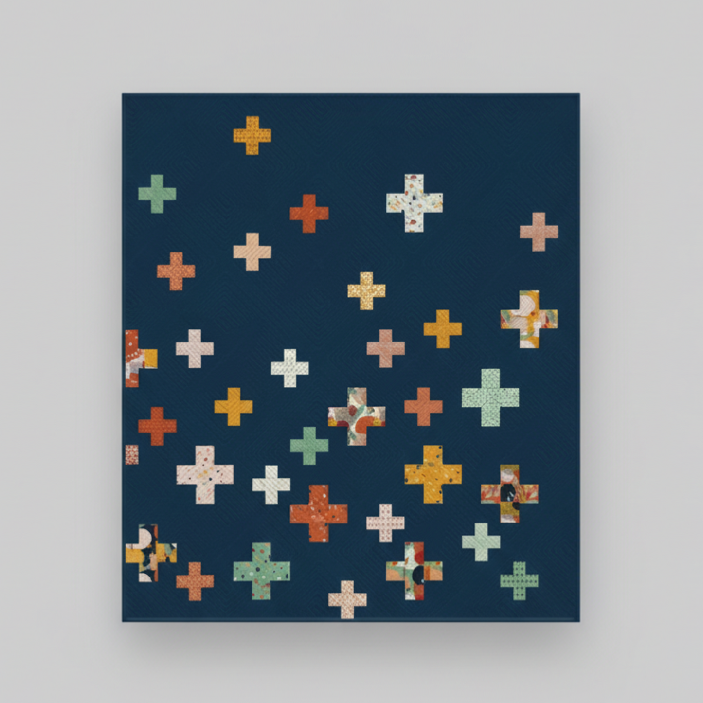 Quilt with colorful crosses  on a dark blue background