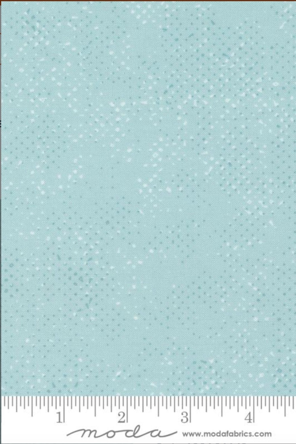 Spotted Mist fabric by Zen Chic for Moda Fabrics with ruler showing print scale – soft pale icy aqua-blue tonal speckled near-solid blender for quilt backgrounds and borders, 100% cotton, 43–44" wide