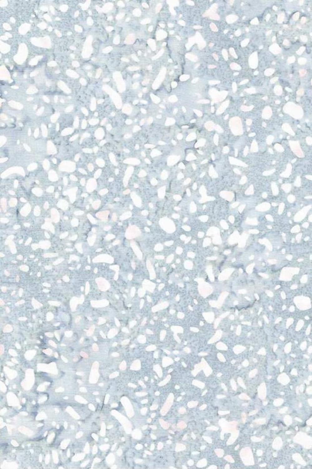 Terrazzo Powdered Pearl Fabric by Riley Blake Designs, showing irregular white and soft blush flecks across a mottled pale blue-gray background.
