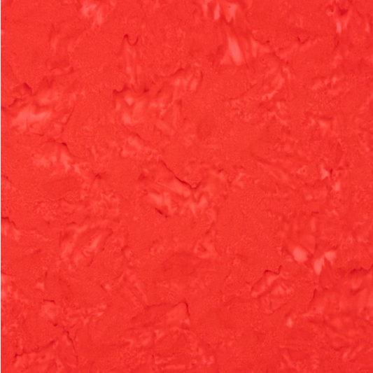 Close-up detail of Expressions Batiks Hand-Dyes Tomato Red quilting cotton fabric highlighting print clarity and vivid warm red-orange tonal hand-dyed batik texture