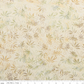 Expressions Batiks Breathe Laurel quilting cotton with Riley Blake Designs ruler showing scale of pattern repeat – cream and ivory tonal batik with feathery fronds, dotted circular swirl outlines, and tiny leaf sprigs in soft sage green and warm taupe, pattern repeat approximately 4–5 inches