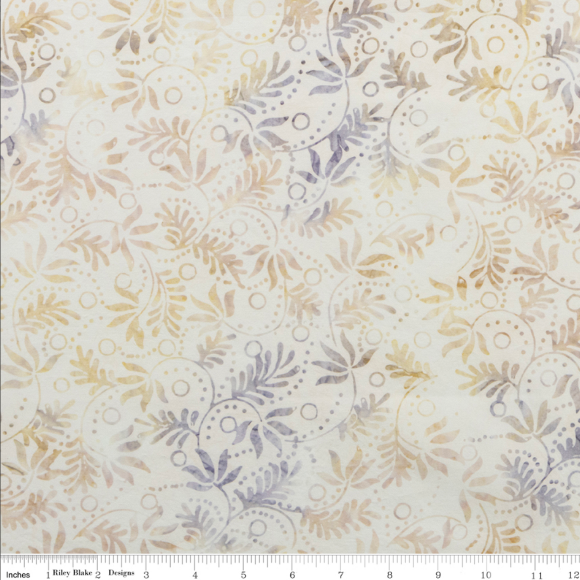 Expressions Batiks Breathe Flaxen by Riley Blake Designs – scale reference with Riley Blake ruler showing pattern repeat of swirling vine, feathery leaf sprigs, and dotted circle motifs in soft warm gold, tan, and lavender-grey on cream ground