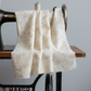 Expressions Batiks Breathe Flaxen by Riley Blake Designs – Pinterest drape shot showing cream batik fabric in soft pleated folds draped over antique black treadle sewing machine with warm wood surface on light grey background