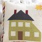 Decorative pillow with house design on a couch
