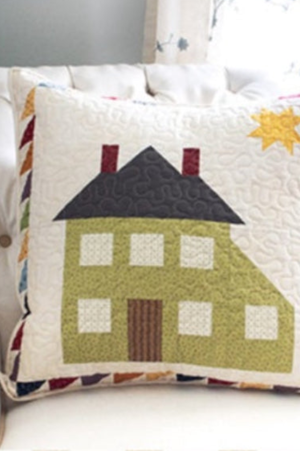 Decorative pillow with house design on a couch