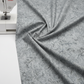 Expressions Batiks Hand-Dyed Charcoal – fabric draped over edge of sewing machine showing charcoal hand-dyed batik texture and drape