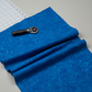 Expressions Batiks Hand-Dyed Imperial – fabric laying on table with rotary cutter and cutting mat visible, imperial blue hand-dyed batik