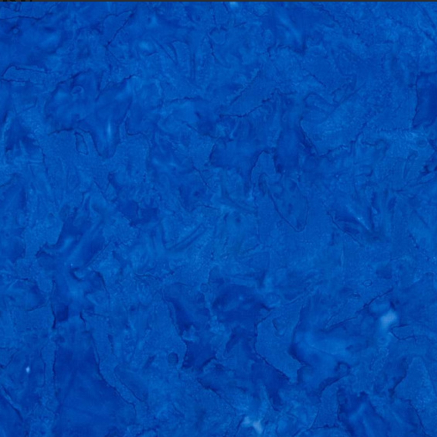 Close-up detail of Expressions Batiks Hand-Dyed Cobalt quilting cotton fabric highlighting print clarity and texture