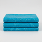 Expressions Batiks Hand-Dyes Hand-Dyed Ocean Blue quilting cotton fabric by Riley Blake Designs – ocean blue hand-dyed batik with organic tonal variation shown folded on light grey background