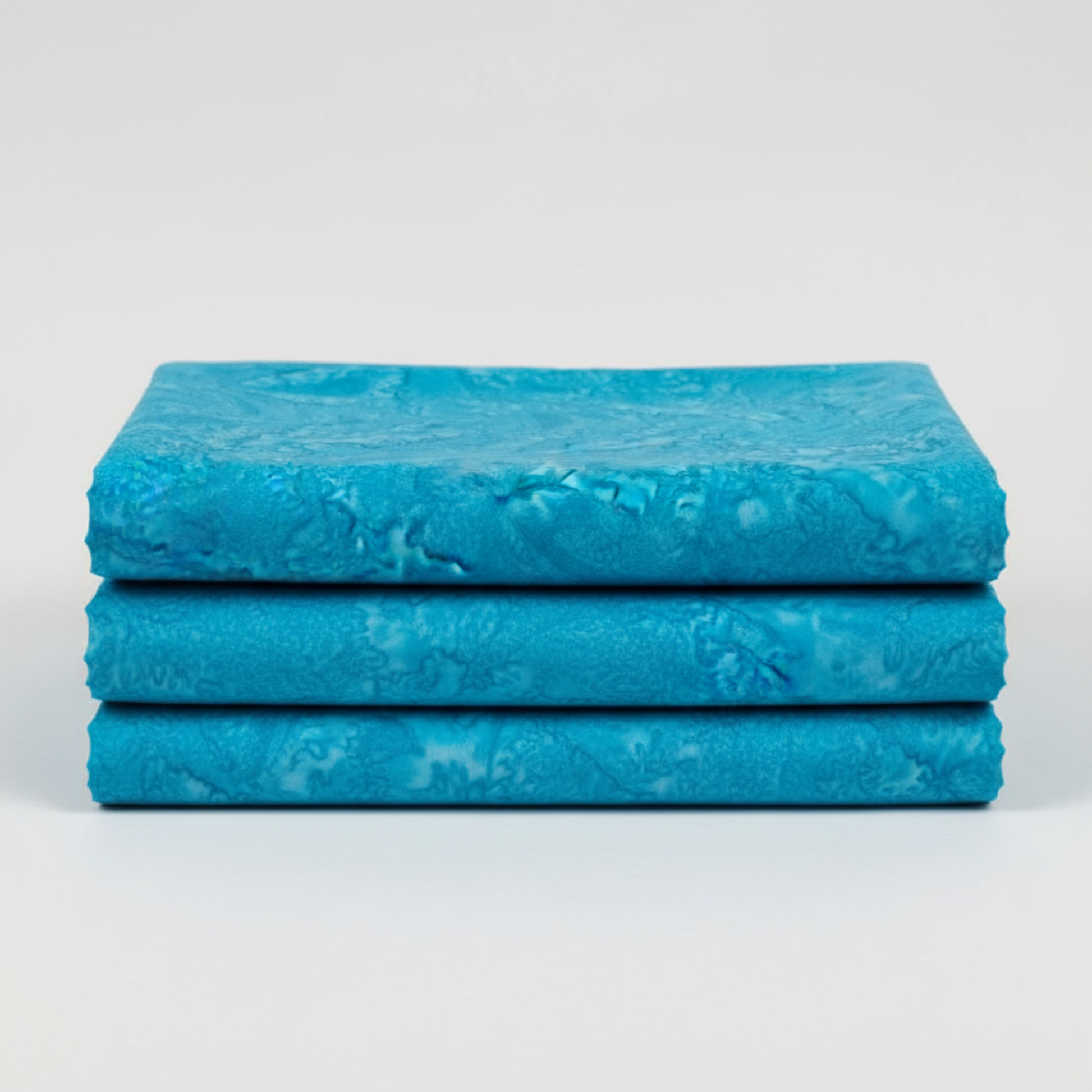 Expressions Batiks Hand-Dyes Hand-Dyed Ocean Blue quilting cotton fabric by Riley Blake Designs – ocean blue hand-dyed batik with organic tonal variation shown folded on light grey background