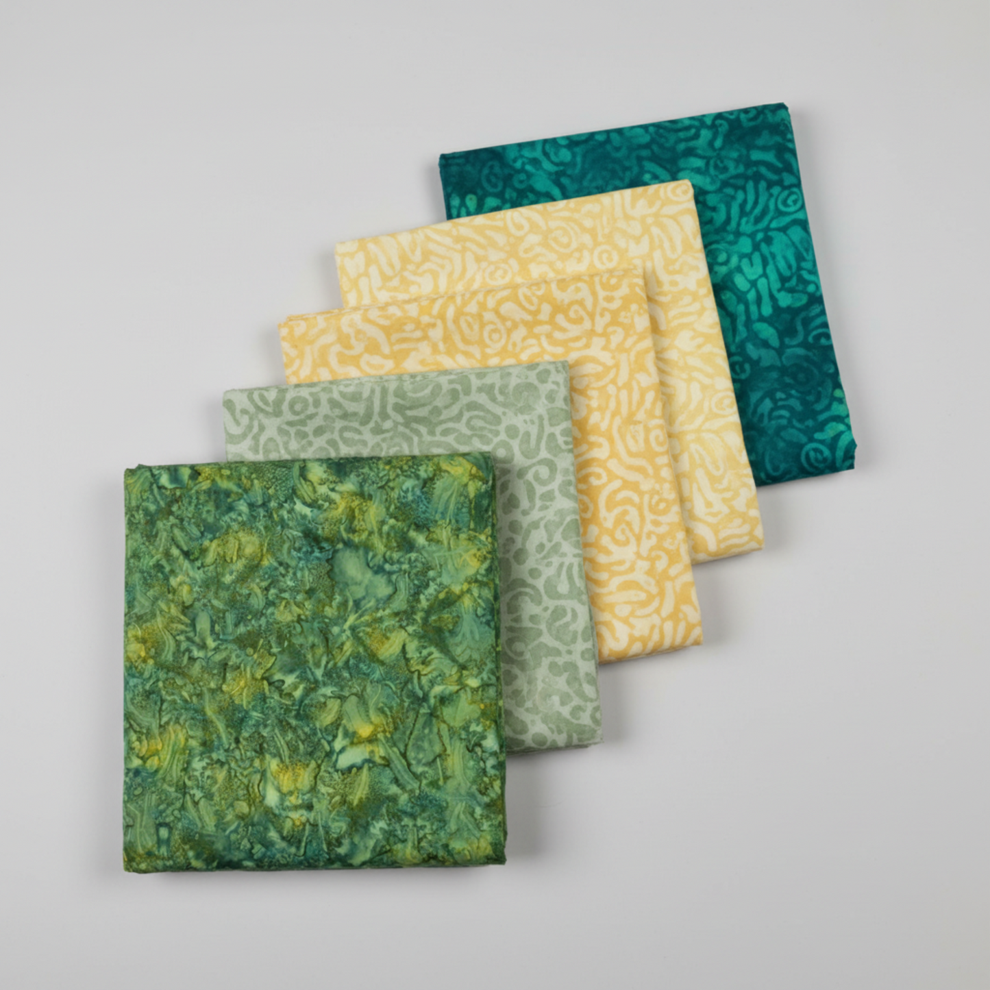 Expressions Batiks Hand-Dyes quilting cotton fabrics including Amazon – 5 coordinating fabrics in complementary colors slightly fanned on light grey background