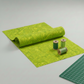 Expressions Batiks Hand-Dyed Sap quilting cotton fabric by Riley Blake Designs – vivid chartreuse green batik ready for quilting project with threads and edge of cutting mat visible on light grey background