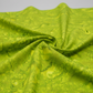 Expressions Batiks Hand-Dyed Sap quilting cotton fabric by Riley Blake Designs – vivid chartreuse yellow-green hand-dyed batik in soft folds on flat surface showing texture and tonal variation