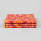 Expressions Batiks Hand-Dyed Bouquet quilting cotton fabric by Riley Blake Designs – premium 100% cotton showing vibrant golden orange, hot pink, magenta, crimson, and lavender painterly hand-dyed batik