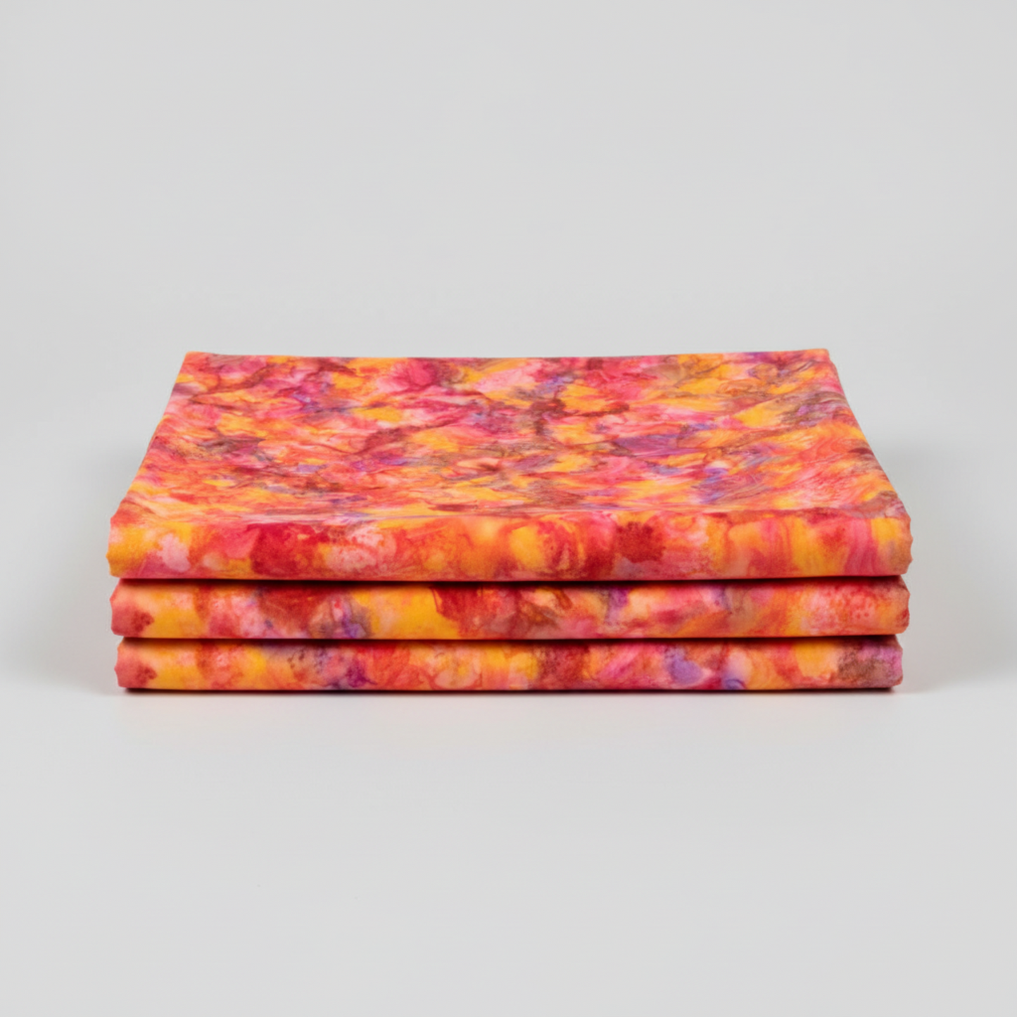 Expressions Batiks Hand-Dyed Bouquet quilting cotton fabric by Riley Blake Designs – premium 100% cotton showing vibrant golden orange, hot pink, magenta, crimson, and lavender painterly hand-dyed batik