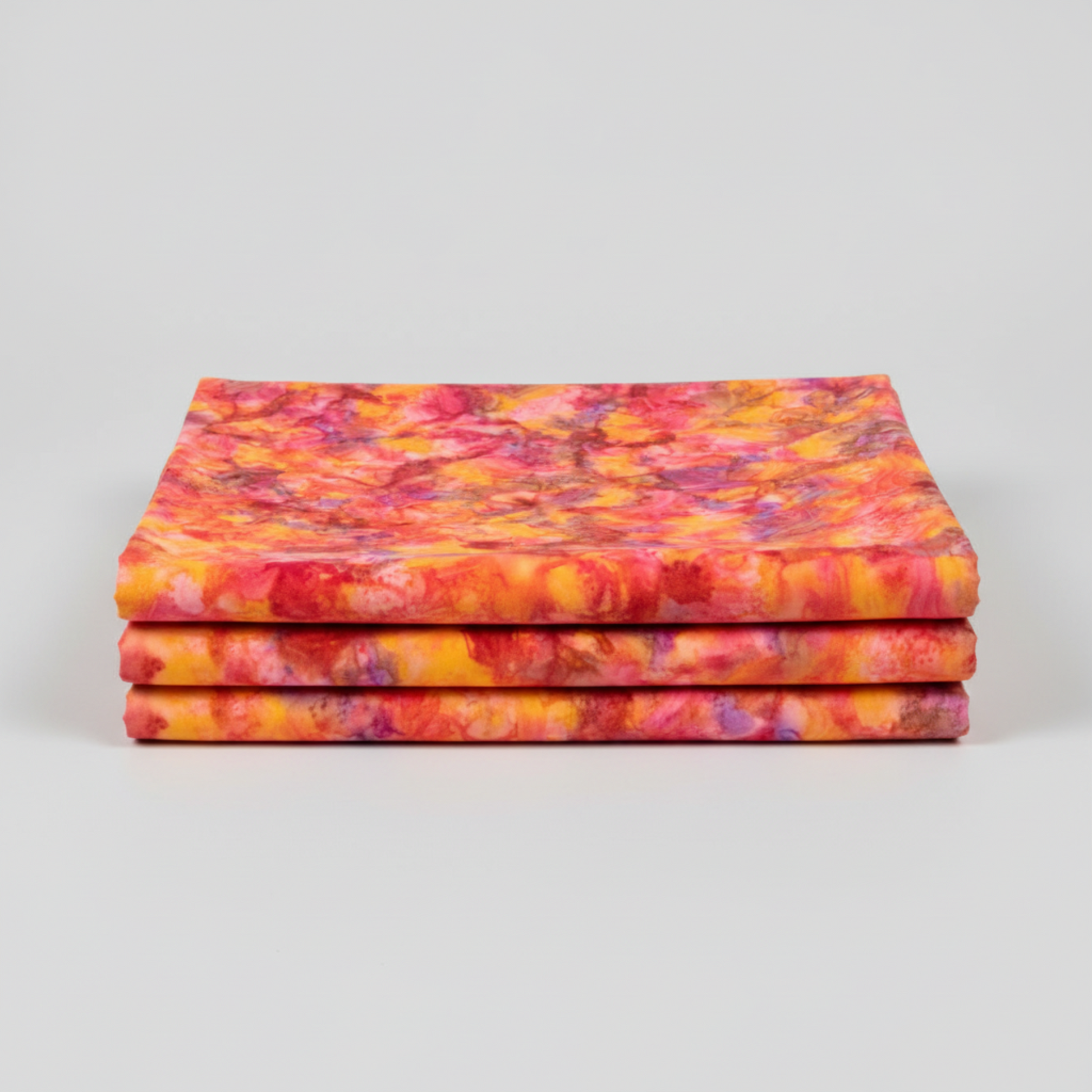 Expressions Batiks Hand-Dyed Bouquet quilting cotton fabric by Riley Blake Designs – premium 100% cotton showing vibrant golden orange, hot pink, magenta, crimson, and lavender painterly hand-dyed batik