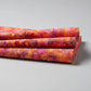 Expressions Batiks Hand-Dyed Bouquet quilting cotton fabric by Riley Blake Designs – vibrant multicolor hand-dyed batik arranged in 3–5 soft natural folds on flat surface showing drape and softness