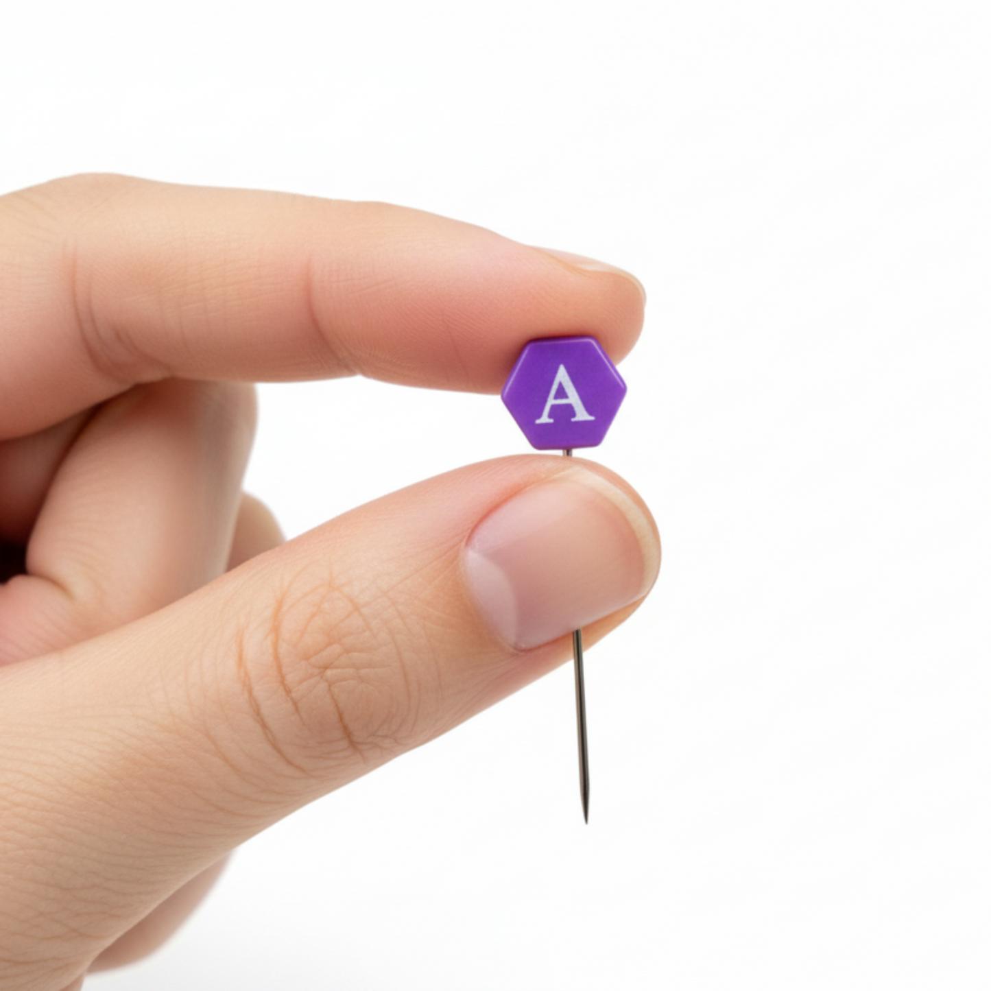 Close-up of Taylor Seville Magic Alphabet pin showing purple comfort grip letter head