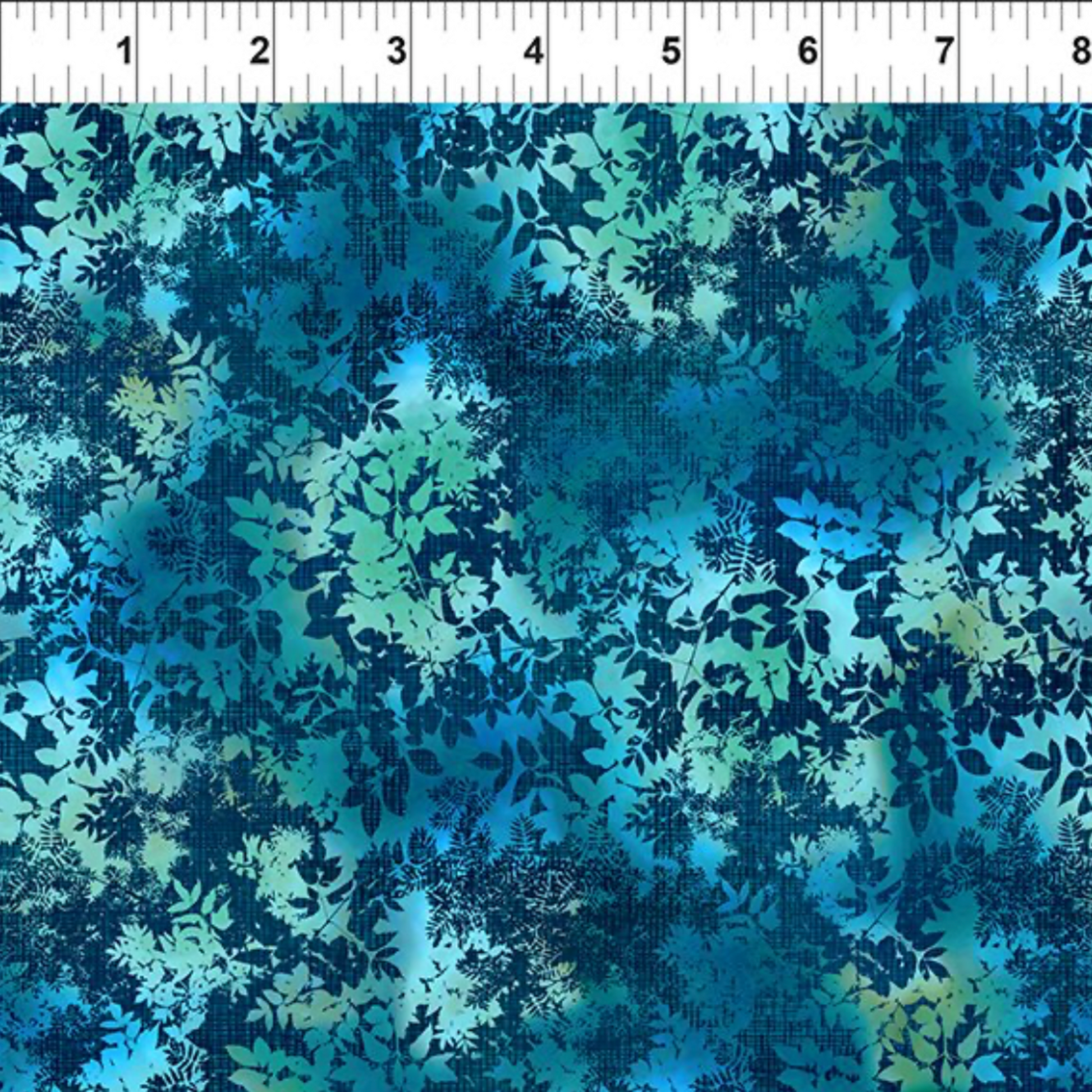 La Luna Teal Leaves quilting cotton fabric with ruler showing print scale – dense allover tonal leaf silhouette print with fern fronds, maple leaves, and botanical sprigs in aqua, teal, chartreuse, and deep navy on rich cobalt watercolor wash by Jason Yenter for In The Beginning Fabrics, 100% cotton, 3 yard cut