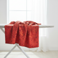 Sunshine Red Daisies fabric draped to show natural movement of 100% cotton material