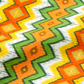 Jungle Friends Multi Stripe 3-yard cut fabric with orange, green, yellow, white, and gold geometric stripes.