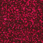 Close-up of Terrazzo Mahogany batik fabric by Riley Blake Designs, showing raspberry-magenta pebble-shaped speckles on a mottled deep burgundy ground.