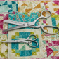 Moda 50 Years fabric scissors cutting quilting cotton on colorful patchwork quilt