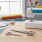 Moda 50 Years scissors set on sewing table with sewing machine and quilting tools
