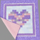 Quilt with a geometric pattern on a gray background