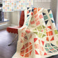 Hopscotch Happy quilt pattern by Robin Pickens — stunning HST design in 4 sizes, Layer Cake, Charm Pack & Fat Quarter friendly! Shop at IraRobi Quilts! #QuiltPattern #RobinPickens #HalfSquareTriangle #ModaFabrics