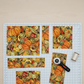Autumn Celebration Multi Vegetables quilting cotton styled on cutting mat with quilting tools – lifestyle shot for quilters