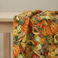 Folded Autumn Celebration fall vegetable fabric highlighting color variation and scale of the pumpkin and squash print.