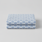 Detailed view of NYSNO Blue Snowflake Grid cotton fabric highlighting crisp snowflake pattern and texture