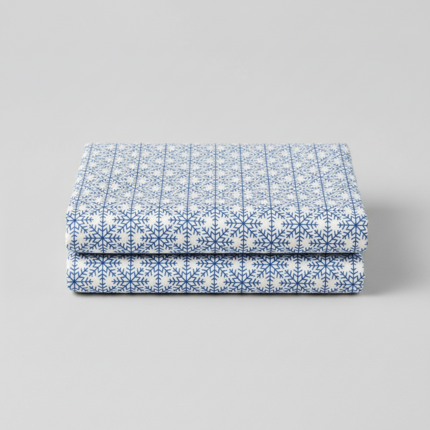 Detailed view of NYSNO Blue Snowflake Grid cotton fabric highlighting crisp snowflake pattern and texture