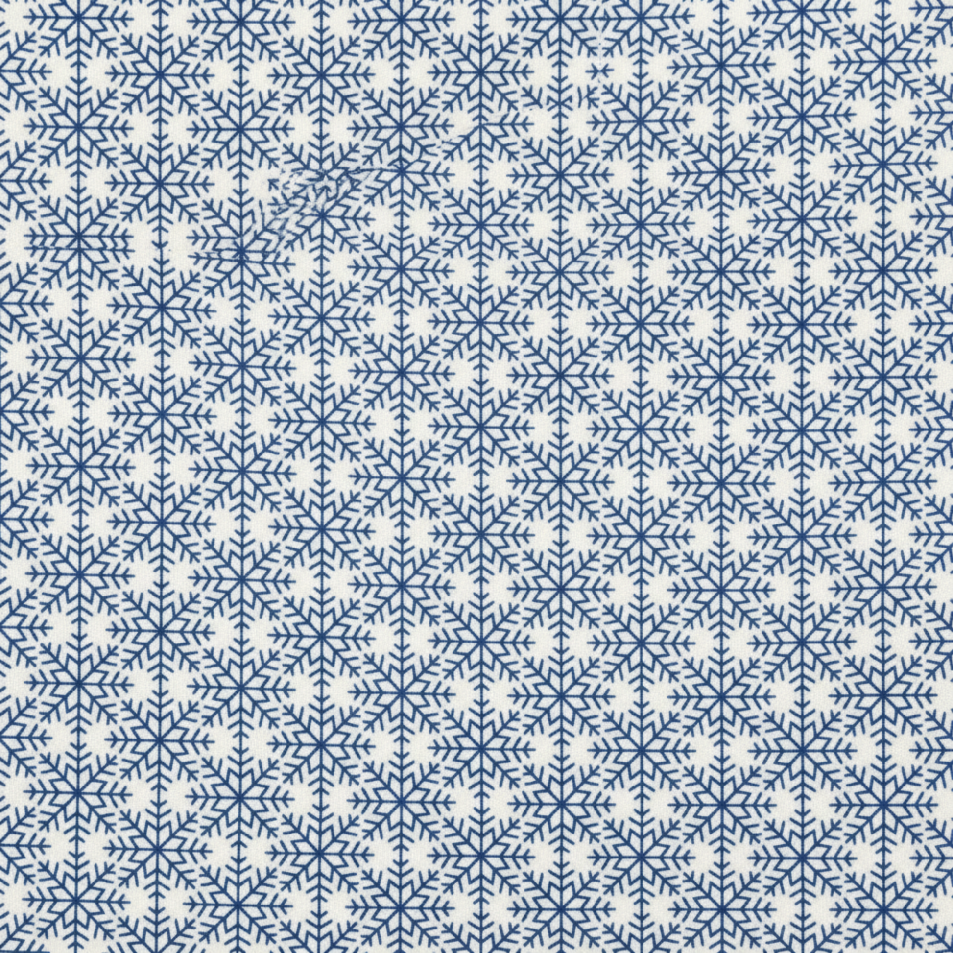 Close-up of NYSNO Blue Snowflake Grid quilting cotton showing detailed blue snowflakes in geometric layout